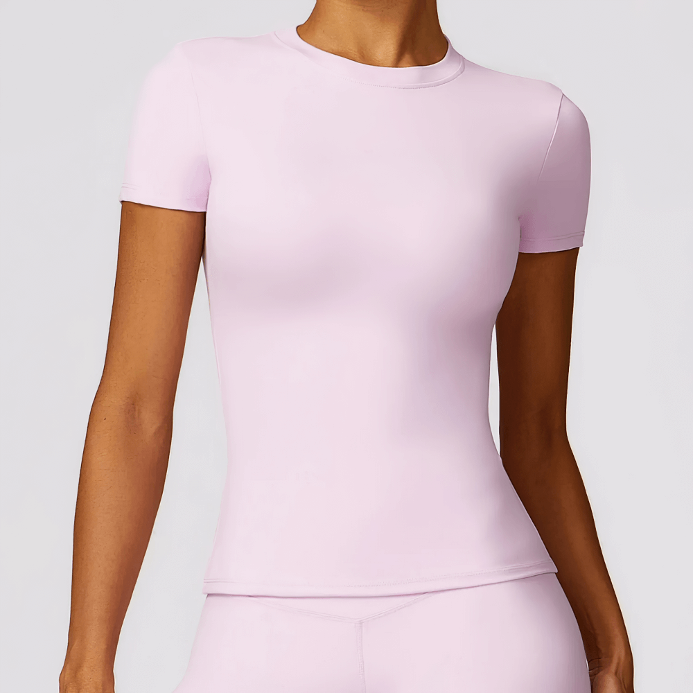 Women's seamless short-sleeve yoga t-shirt in light pink, featuring a compressed fit for enhanced mobility and breathability during workouts.